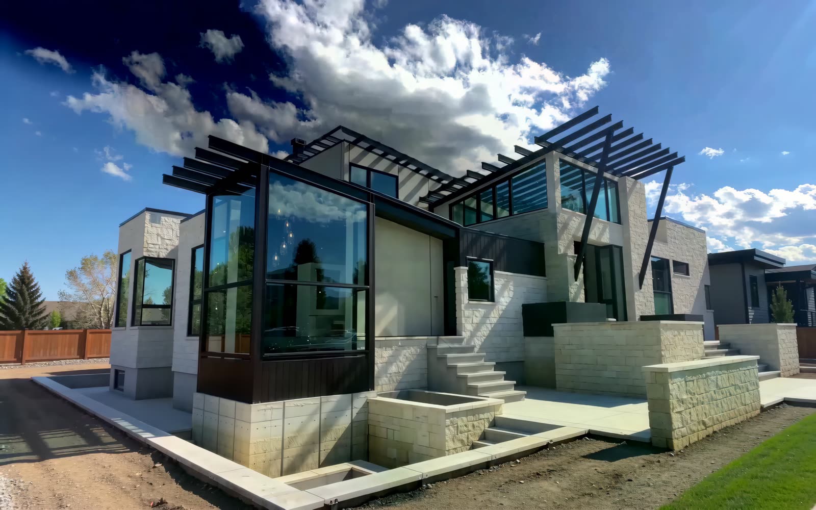 Exterior envelope with pale stone and dark panels being installed — frame from the brand film